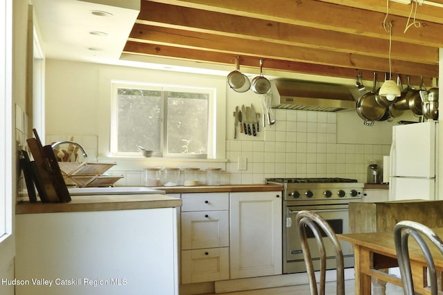 1130 Sawkill Rd, Kingston, NY 12401 - kitchen with freestanding refrigerator, luxury range, exhaust hood, and backsplash