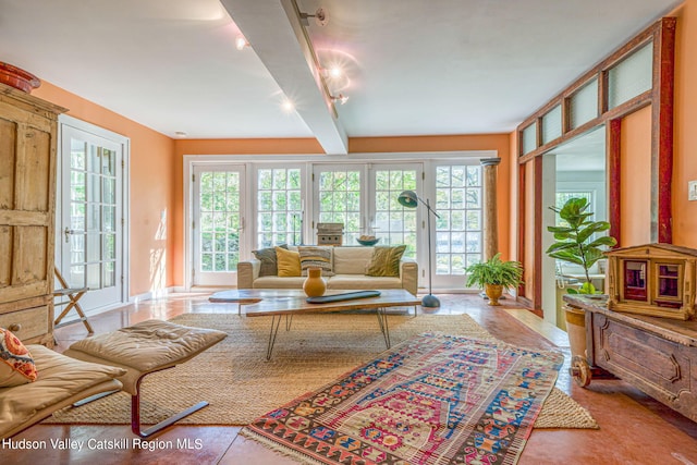 living area with a wealth of natural light and beamed ceiling