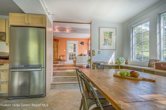 kitchen with light tile patterned flooring and freestanding refrigerator
