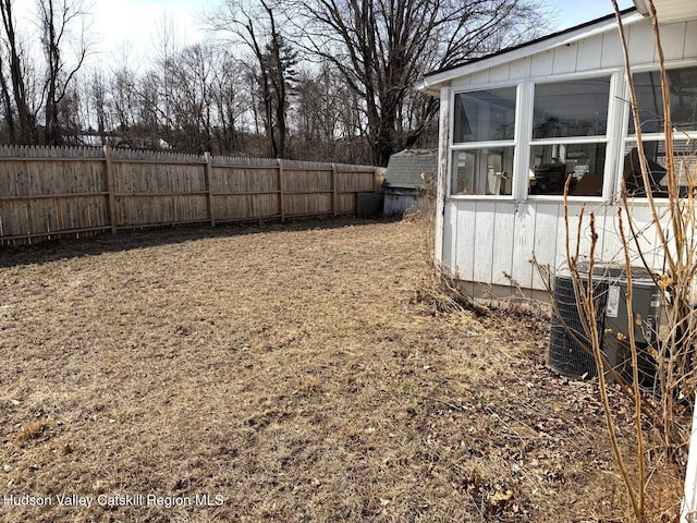 view of yard featuring cooling unit and fence