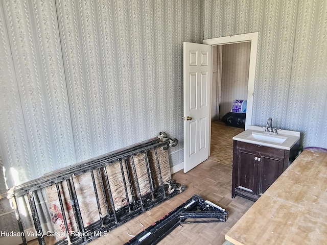 bathroom with parquet flooring and sink