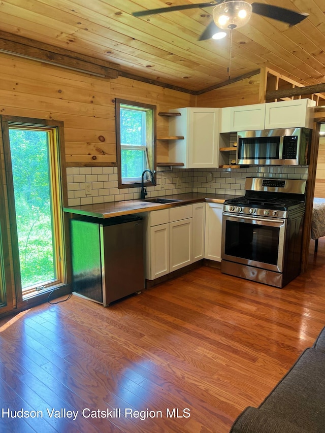 36 Rodney St, Kingston, NY 12401 - kitchen with open shelves, wood ceiling, appliances with stainless steel finishes, white cabinetry, and dark wood-style flooring