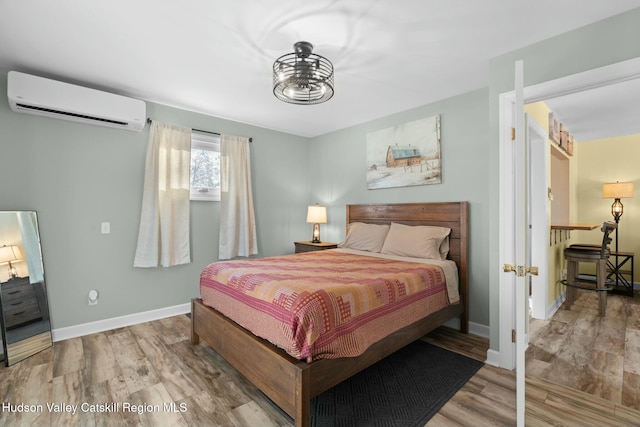 1920 Old Kings Hwy, Saugerties, NY 12477 - bedroom with a wall mounted air conditioner, baseboards, and wood finished floors