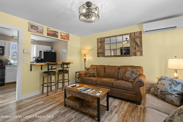 1920 Old Kings Hwy, Saugerties, NY 12477 - living room featuring baseboards, wood finished floors, and a wall mounted AC