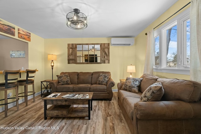 1920 Old Kings Hwy, Saugerties, NY 12477 - living area featuring baseboards, wood finished floors, a wall mounted AC, and an inviting chandelier