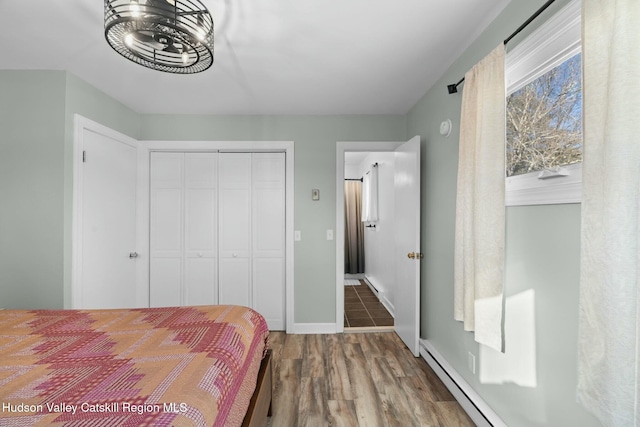 1920 Old Kings Hwy, Saugerties, NY 12477 - bedroom with baseboards, wood finished floors, a closet, and a baseboard radiator