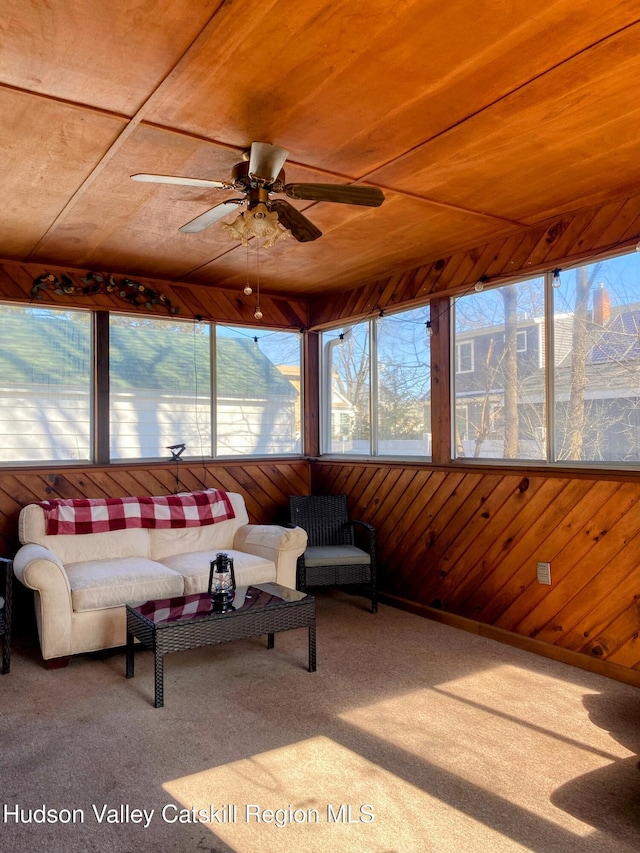 sunroom featuring ceiling fan, wooden ceiling, and a healthy amount of sunlight