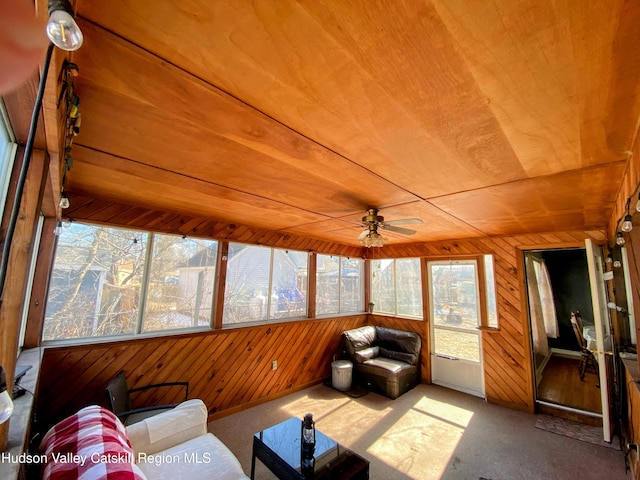 sunroom with wooden ceiling and ceiling fan