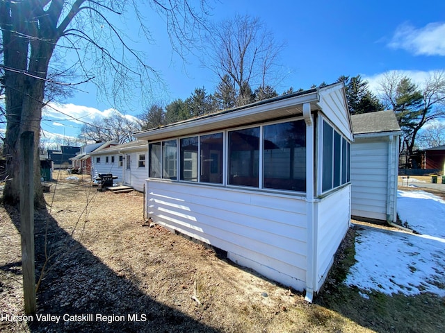 view of side of property with a sunroom