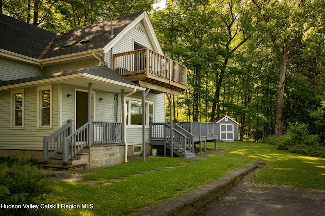 186 2nd St, Port Ewen, NY 12417 - view of front facade featuring a front yard, a balcony, and a shingled roof