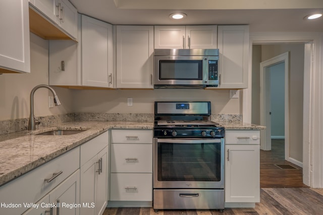 186 2nd St, Port Ewen, NY 12417 - kitchen featuring appliances with stainless steel finishes, a sink, dark wood-style floors, recessed lighting, and white cabinets