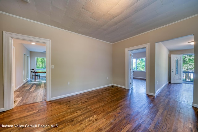 186 2nd St, Port Ewen, NY 12417 - empty room featuring dark wood finished floors, crown molding, plenty of natural light, and baseboards