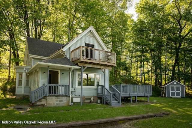 186 2nd St, Port Ewen, NY 12417 - view of front facade featuring a balcony, a shingled roof, a front lawn, and view of scattered trees