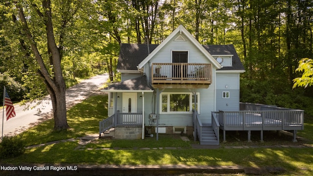 186 2nd St, Port Ewen, NY 12417 - rear view of property featuring a balcony, a lawn, and view of wooded area