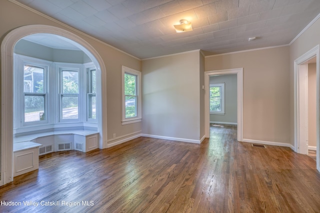 186 2nd St, Port Ewen, NY 12417 - unfurnished room featuring wood finished floors, healthy amount of natural light, crown molding, arched walkways, and baseboards