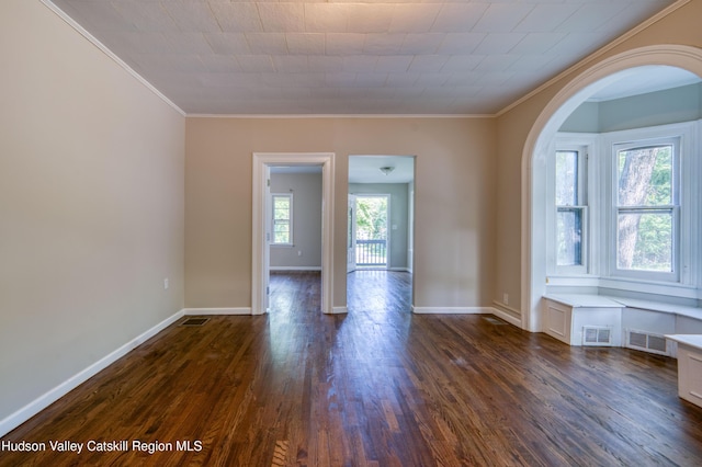 186 2nd St, Port Ewen, NY 12417 - unfurnished room featuring ornamental molding, arched walkways, dark wood-style floors, and baseboards
