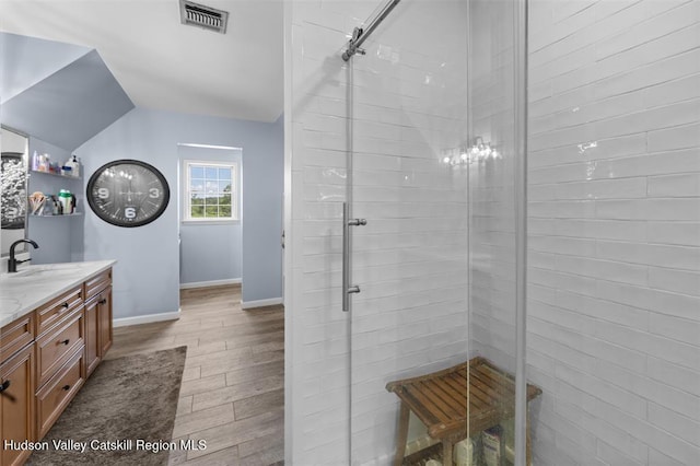 10 Sutton Ln, Goshen, NY 10924 - bathroom with vanity, a shower stall, wood finished floors, and lofted ceiling