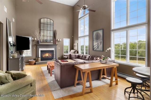 10 Sutton Ln, Goshen, NY 10924 - living room with ceiling fan, high vaulted ceiling, healthy amount of natural light, wood finished floors, and a high end fireplace