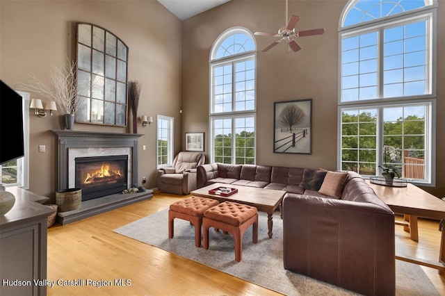 10 Sutton Ln, Goshen, NY 10924 - living area featuring a high ceiling, a ceiling fan, wood finished floors, and a premium fireplace