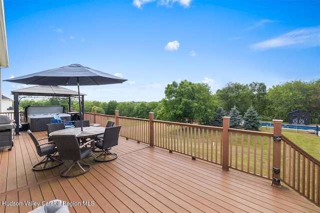 10 Sutton Ln, Goshen, NY 10924 - wooden deck with a hot tub, outdoor dining area, a gazebo, and a lawn