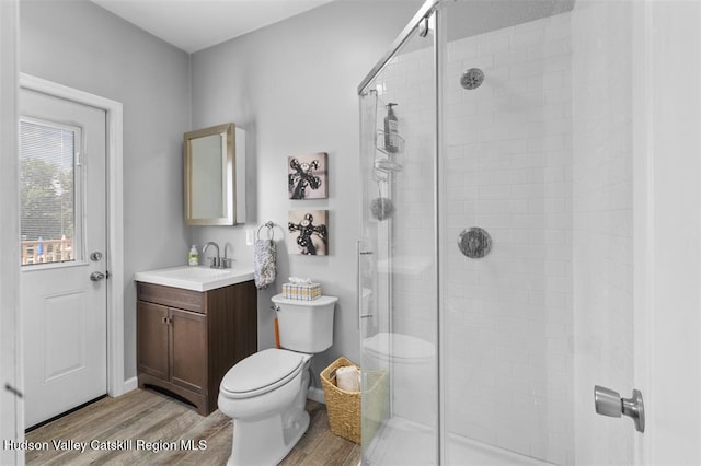 10 Sutton Ln, Goshen, NY 10924 - full bathroom featuring wood finished floors, a shower stall, and vanity