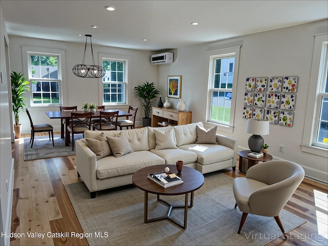 42 Ulster Ave, Saugerties, NY 12477 - living room featuring light wood finished floors, a wall unit AC, recessed lighting, and a chandelier