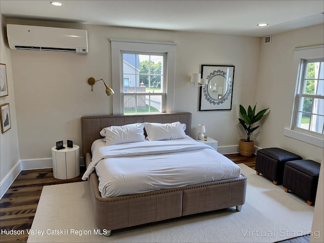 42 Ulster Ave, Saugerties, NY 12477 - bedroom featuring an AC wall unit, wood finished floors, and recessed lighting