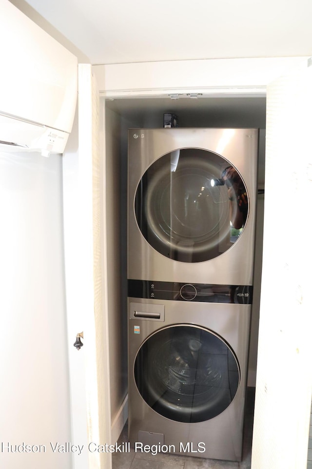 42 Ulster Ave, Saugerties, NY 12477 - washroom featuring stacked washer / dryer and a wall mounted air conditioner