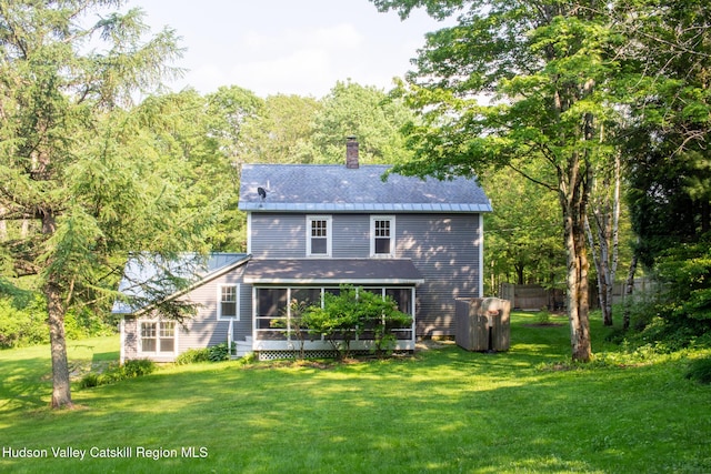 477 Fog Hill Rd, Austerlitz, NY 12017 - rear view of house with a sunroom, a chimney, and a lawn