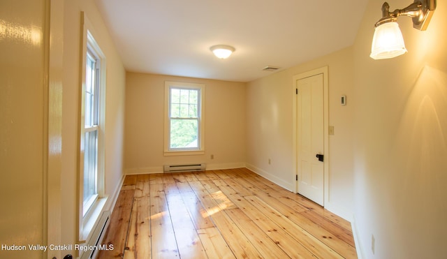 477 Fog Hill Rd, Austerlitz, NY 12017 - empty room with a baseboard heating unit and light wood finished floors