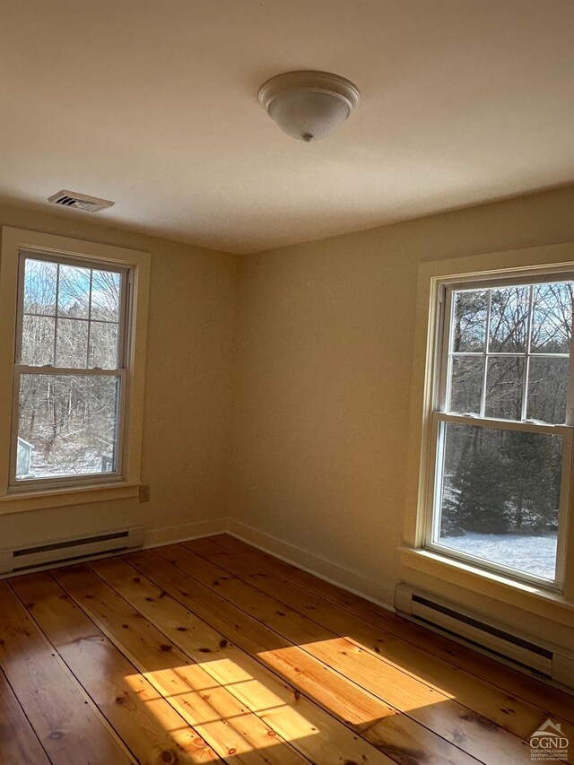 477 Fog Hill Rd, Austerlitz, NY 12017 - unfurnished room featuring baseboard heating, hardwood / wood-style flooring, and baseboards