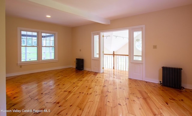 477 Fog Hill Rd, Austerlitz, NY 12017 - spare room with radiator heating unit, light wood-type flooring, beamed ceiling, and recessed lighting