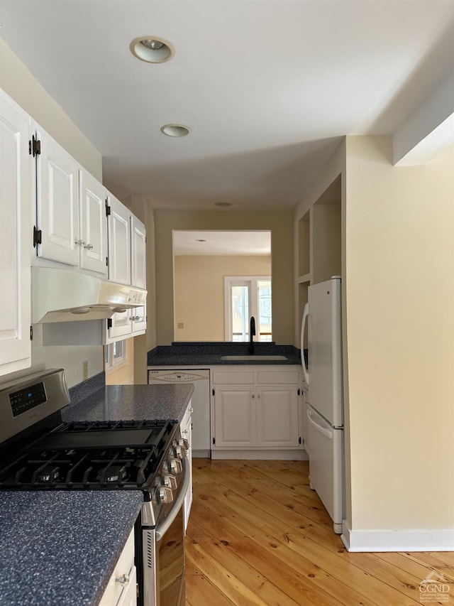 477 Fog Hill Rd, Austerlitz, NY 12017 - kitchen with white appliances, a sink, under cabinet range hood, light wood finished floors, and dark countertops