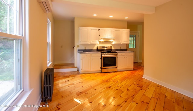477 Fog Hill Rd, Austerlitz, NY 12017 - kitchen featuring gas range, radiator, a wall mounted air conditioner, dark countertops, and recessed lighting
