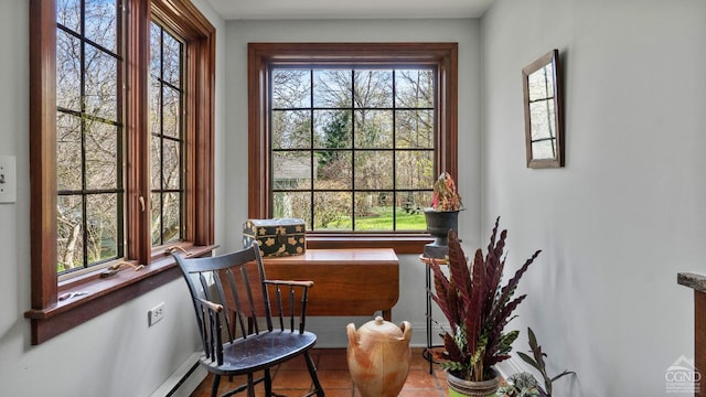 sitting room featuring baseboards and tile patterned flooring