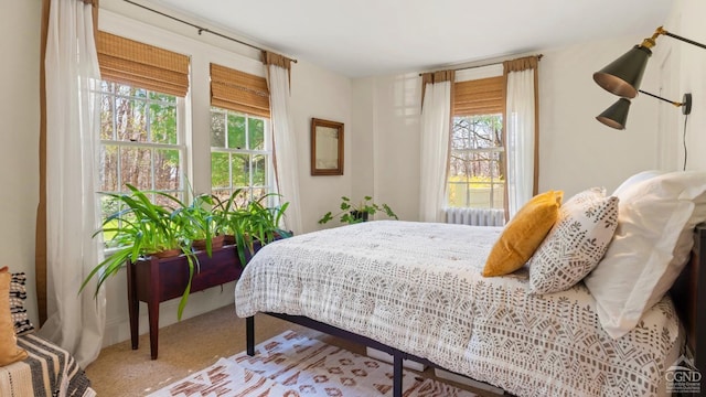 carpeted bedroom featuring radiator