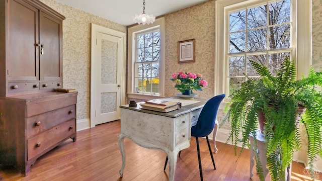 office featuring wallpapered walls, light wood finished floors, and baseboards