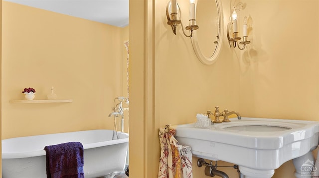 full bathroom featuring a soaking tub and a sink