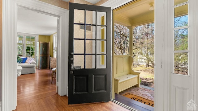 doorway to outside featuring plenty of natural light and wood finished floors