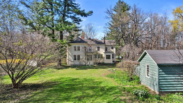 view of green lawn featuring an outdoor structure