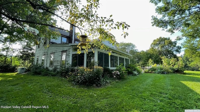 3766 US Route 9, Hudson, NY 12534 - view of property exterior with a sunroom, a lawn, and central AC