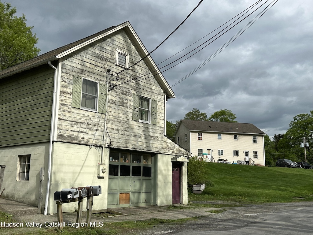 view of home's exterior with a yard and an attached garage