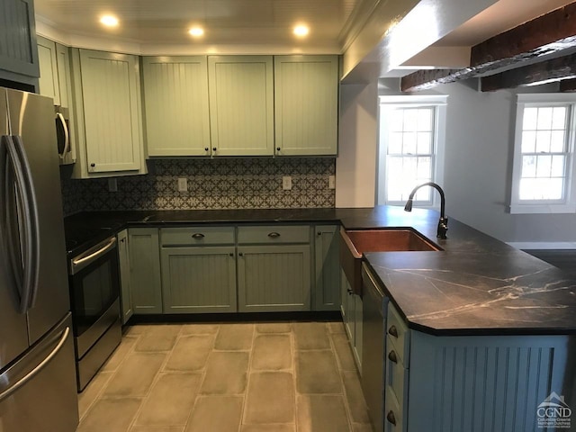 11293 Rte 32, Greenville, NY 12083 - kitchen featuring appliances with stainless steel finishes, a peninsula, dark countertops, green cabinetry, and tasteful backsplash