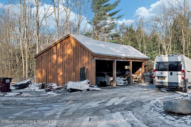 snow covered property with an outdoor structure