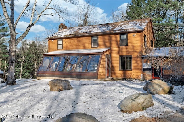 view of front of home featuring a sunroom