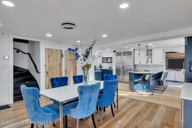 dining room featuring light wood-type flooring and sink