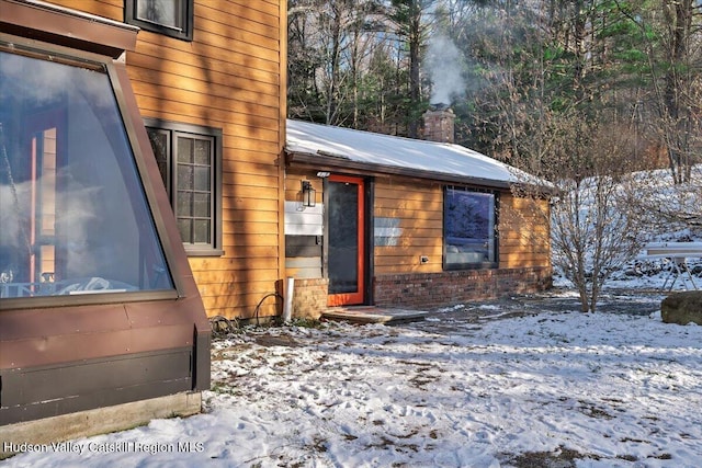 view of snow covered property entrance