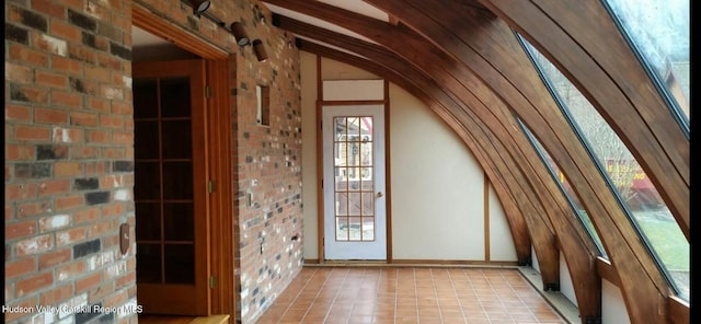 unfinished attic featuring a healthy amount of sunlight