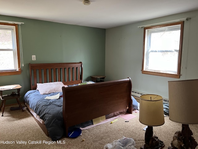 carpeted bedroom with a baseboard radiator