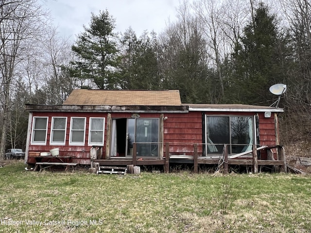 rear view of house with a yard